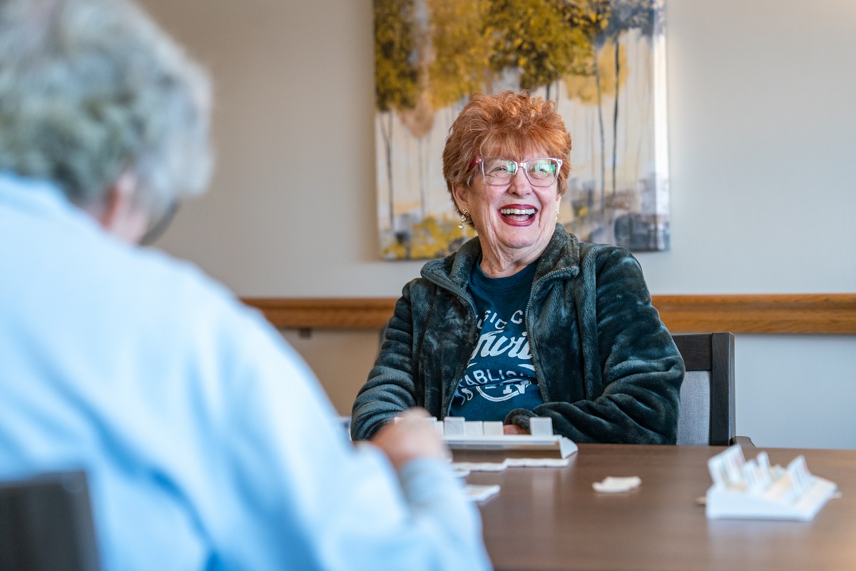 Sholom Community Ambassador Program member Sally laughing while playing a game