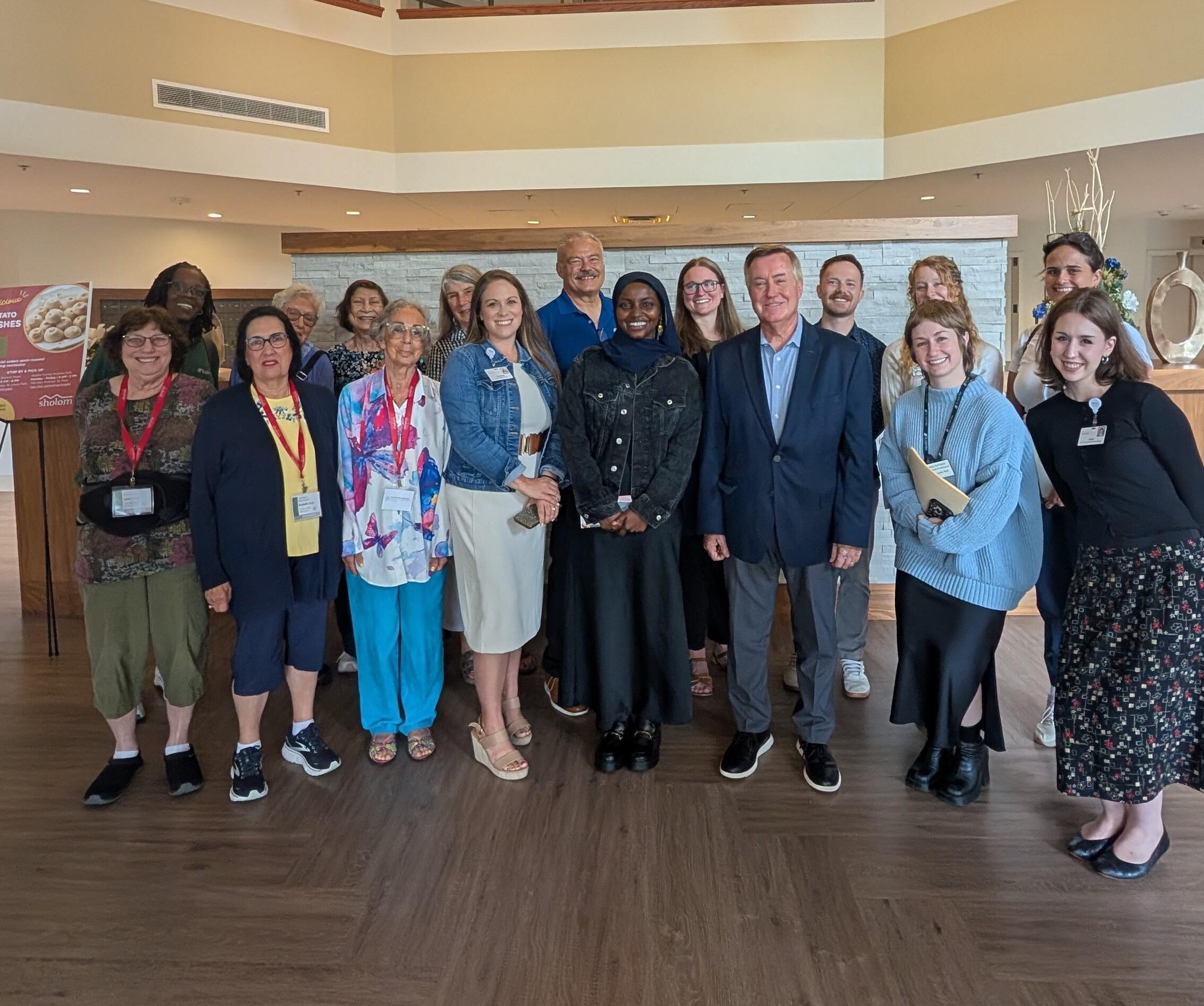 Mayor Mohamed and St. Louis Park City Council Members pose for a picture at Knollwood Place Apartments 55+ Senior Independent Living in St. Louis Park